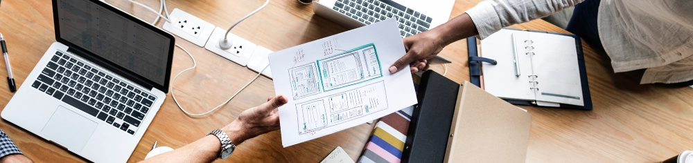 Two people looking over some website security plans.